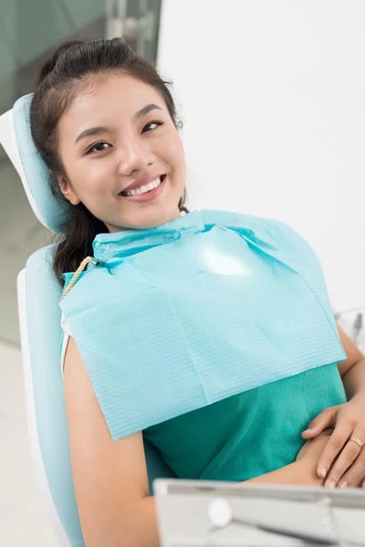 woman smiling before getting her teeth cleaned at Hrencher Dental