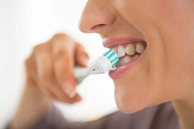 closeup of a woman brushing her teeth