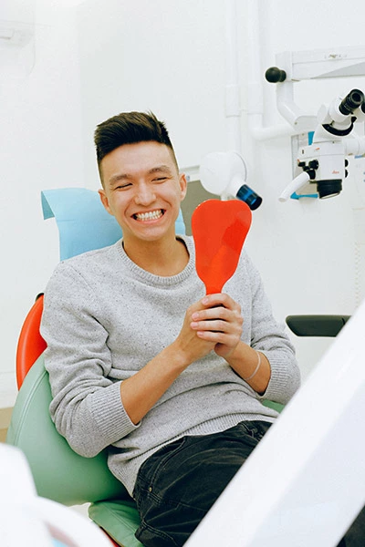 man smiling after getting his teeth cleaned at Hrencher Dental